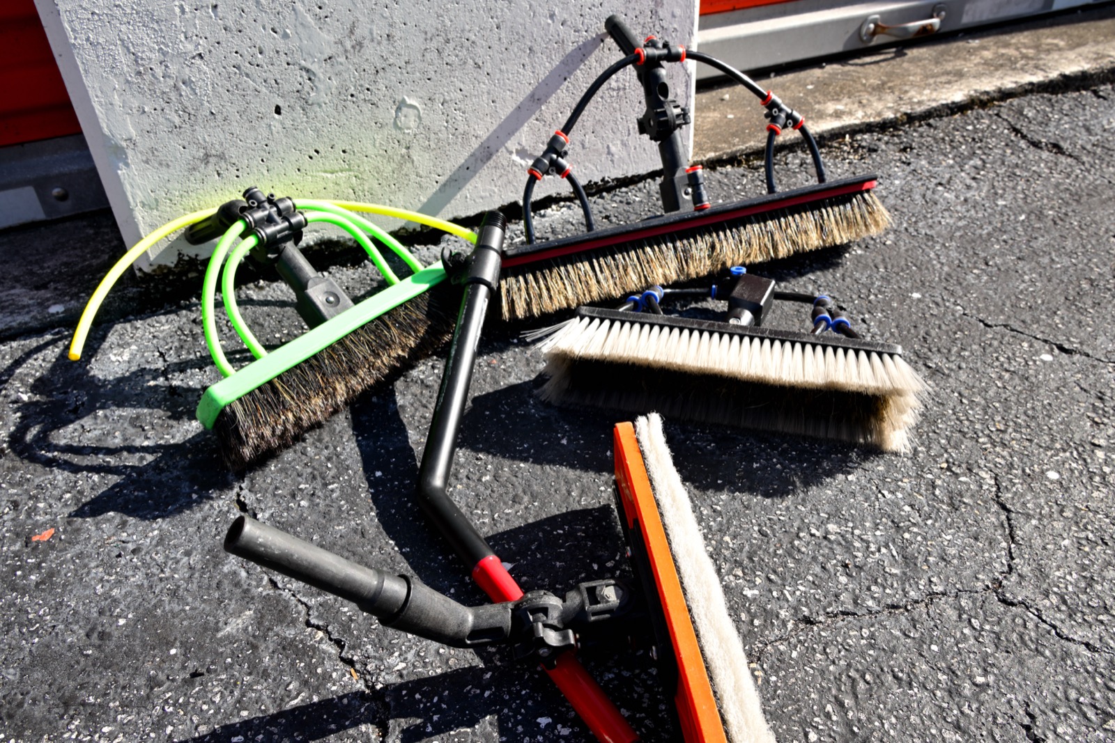 Water-fed pole brushes used by Shiny Windows to clean high windows and solar panels safely from the ground in Miami
